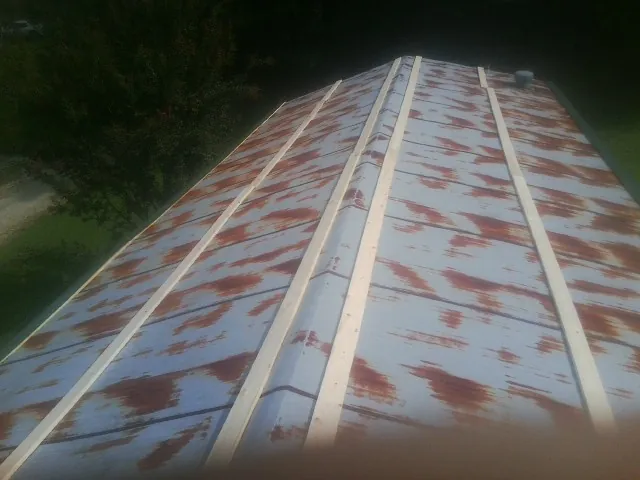 Rusted metal roof panels with new wood purlins before replacement — Storm Damage Roof Repair in Gibsonville by Roofing Brothers